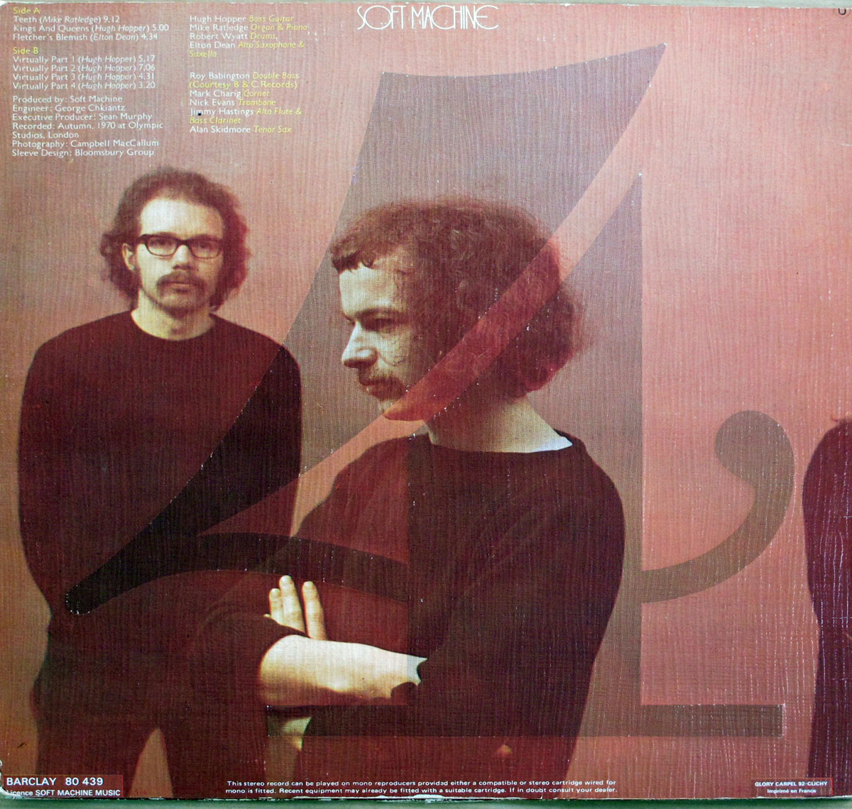 Back cover of Soft Machine's 'Fourth' album, featuring a grainy, reddish-brown toned image of two band members in black sweaters, superimposed with large, stylized typography of the number '4'. One musician is in the foreground with curly hair and a mustache, arms crossed, looking downward. Another, slightly blurred, stands in the background wearing glasses, staring directly at the camera. Tracklist and credits are in the upper left corner.